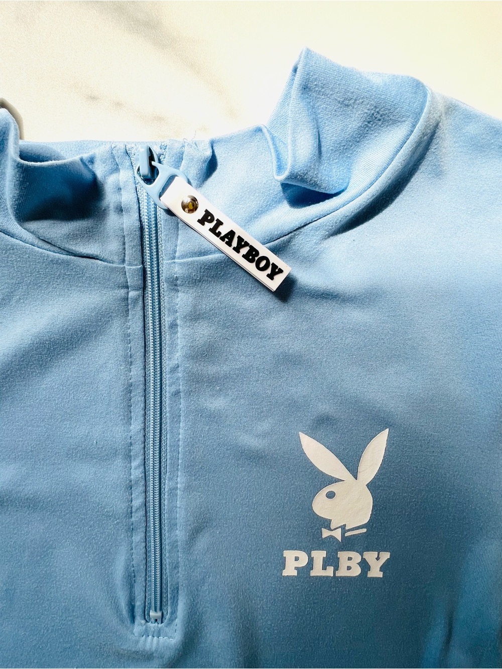 Playboy Baby Blue Short Sleeve Zip-up Mock Neck Short Sleeve Crop Top PLBY